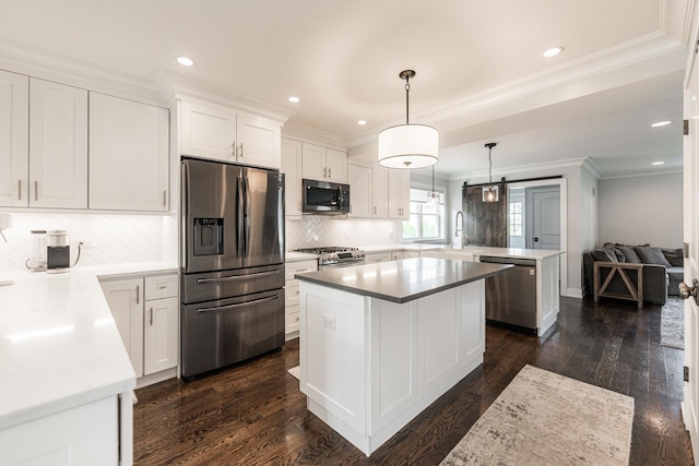 732 S Mitchell Ave, Elmhurst, IL 60126 - kitchen featuring appliances with stainless steel finishes, a peninsula, dark wood-type flooring, ornamental molding, and tasteful backsplash