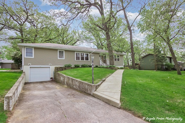 5704 N Woodland Dr, Mchenry, IL 60050 - ranch-style house featuring a garage, asphalt driveway, and a front lawn