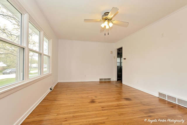 5704 N Woodland Dr, Mchenry, IL 60050 - spare room featuring light wood finished floors, ornamental molding, baseboards, and ceiling fan