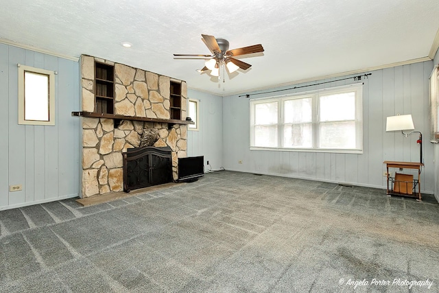 5704 N Woodland Dr, Mchenry, IL 60050 - unfurnished living room featuring a ceiling fan, carpet, a stone fireplace, and baseboards