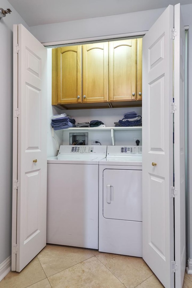 25 E Superior St Unit 2805, Chicago, IL 60611 - laundry room with cabinet space, washer and clothes dryer, baseboards, and light tile patterned floors