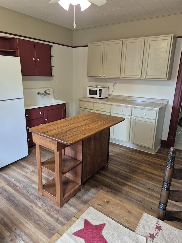 123 W Maple St, Franklin Grove, IL 61031 - kitchen featuring white appliances, wood finished floors, ceiling fan, and open shelves