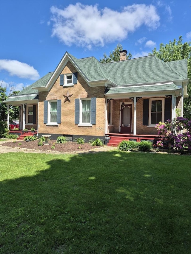 123 W Maple St, Franklin Grove, IL 61031 - view of front facade featuring covered porch, a chimney, a front lawn, brick siding, and roof with shingles