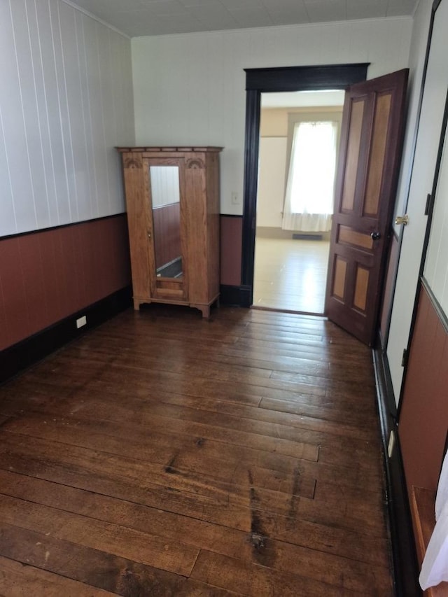 123 W Maple St, Franklin Grove, IL 61031 - unfurnished room featuring dark wood-style floors and wood walls