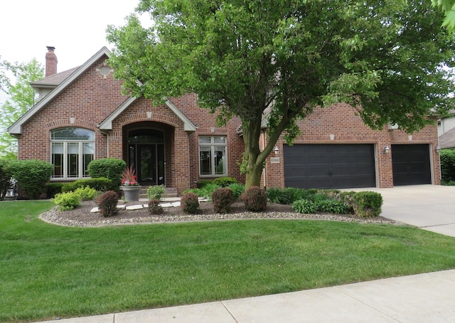 10880 Swallow Tail Ln, Frankfort, IL 60423 - view of front facade with concrete driveway, a front yard, brick siding, an attached garage, and a chimney