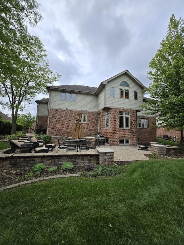 10880 Swallow Tail Ln, Frankfort, IL 60423 - rear view of house featuring a patio area, brick siding, and a lawn