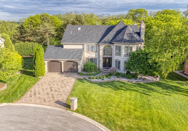 1505 Old Oak Pl, Darien, IL 60561 - view of front facade with an attached garage, decorative driveway, a front yard, and a chimney