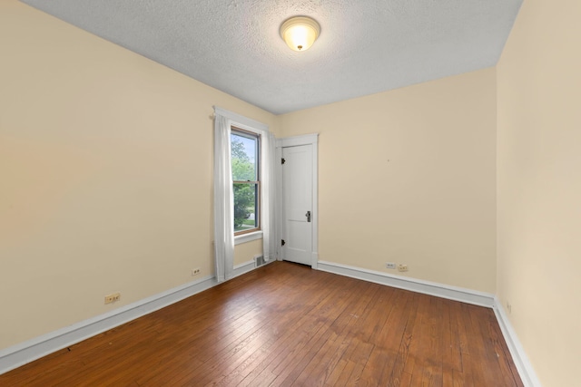 506 Carleton Ave, Glen Ellyn, IL 60137 - spare room with hardwood / wood-style flooring, baseboards, and a textured ceiling