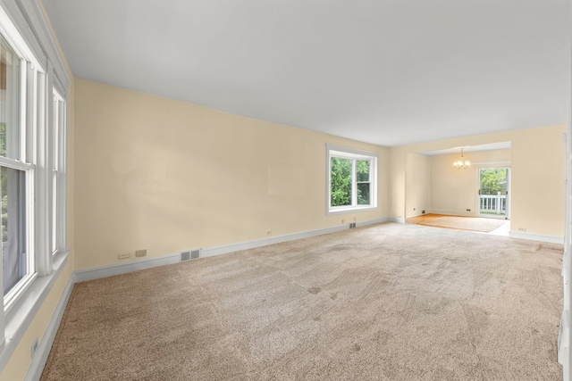 506 Carleton Ave, Glen Ellyn, IL 60137 - unfurnished room with a chandelier, carpet floors, and baseboards