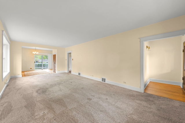 506 Carleton Ave, Glen Ellyn, IL 60137 - carpeted spare room with a chandelier and baseboards