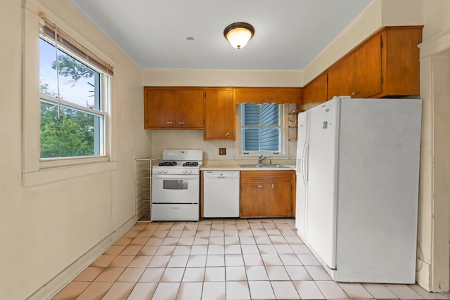 506 Carleton Ave, Glen Ellyn, IL 60137 - kitchen with white appliances, a sink, brown cabinetry, light countertops, and light tile patterned floors