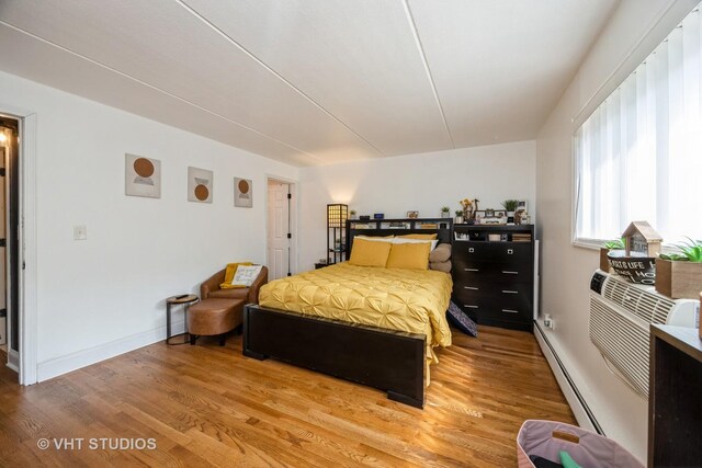914 N Austin Blvd Unit B10, Oak Park, IL 60302 - bedroom with a baseboard heating unit, light wood-style flooring, and baseboards