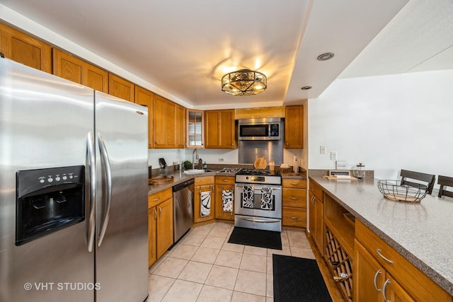 914 N Austin Blvd Unit B10, Oak Park, IL 60302 - kitchen with stainless steel appliances, brown cabinetry, a sink, light tile patterned flooring, and glass insert cabinets