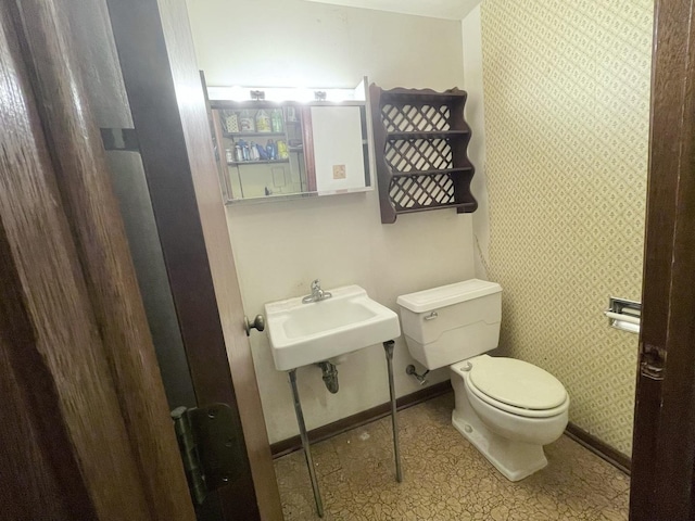 1410 Brentwood Pl, Joliet, IL 60435 - bathroom with toilet, baseboards, wallpapered walls, and a sink