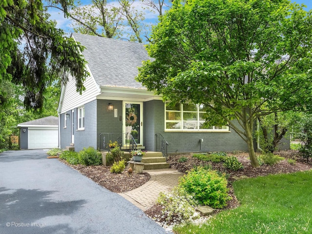 407 Turner Ave, Glen Ellyn, IL 60137 - view of front of property featuring brick siding, a garage, roof with shingles, and an outdoor structure