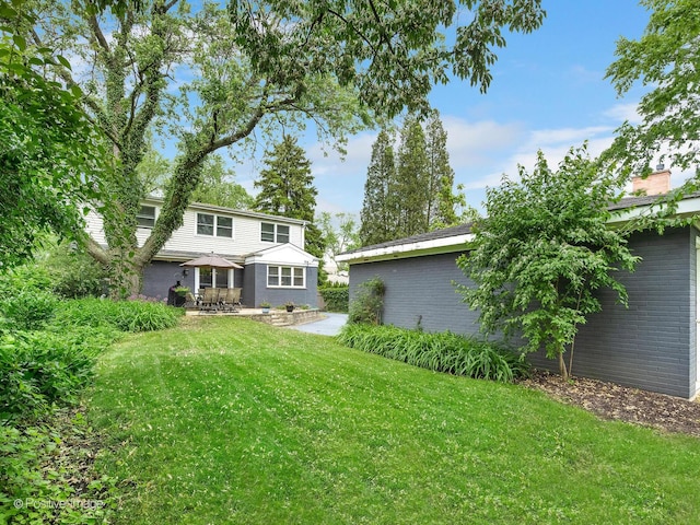 407 Turner Ave, Glen Ellyn, IL 60137 - back of house featuring brick siding, a lawn, a chimney, a patio area, and a gazebo