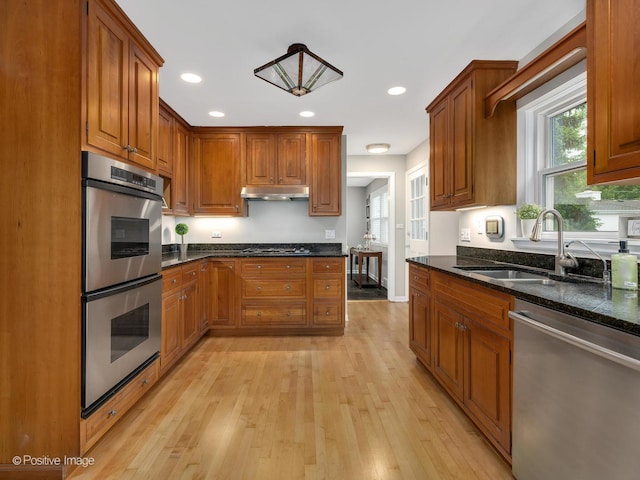 407 Turner Ave, Glen Ellyn, IL 60137 - kitchen with stainless steel appliances, a sink, under cabinet range hood, light wood finished floors, and brown cabinets