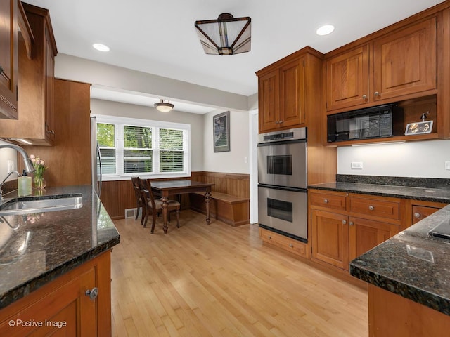 407 Turner Ave, Glen Ellyn, IL 60137 - kitchen featuring double oven, black microwave, a sink, light wood-style flooring, and a wainscoted wall