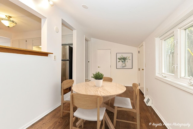 33978 N Lake Rd, Grayslake, IL 60030 - dining space featuring dark wood-type flooring, lofted ceiling, and baseboards