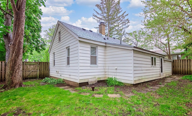 33978 N Lake Rd, Grayslake, IL 60030 - view of home's exterior featuring a chimney and a shingled roof