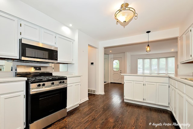 33978 N Lake Rd, Grayslake, IL 60030 - kitchen featuring appliances with stainless steel finishes, light countertops, white cabinetry, a peninsula, and dark wood finished floors