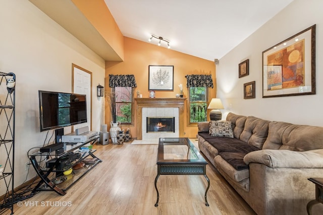 841 Bonnie Brae Ln, Bolingbrook, IL 60440 - living room featuring lofted ceiling, wood finished floors, and a tiled fireplace