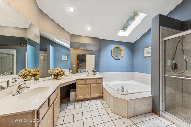 841 Bonnie Brae Ln, Bolingbrook, IL 60440 - bathroom featuring a skylight, vaulted ceiling, vanity, a stall shower, and a garden tub