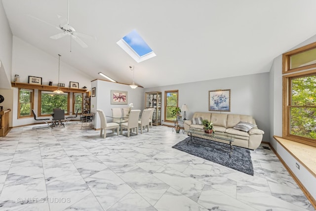 841 Bonnie Brae Ln, Bolingbrook, IL 60440 - living area featuring light marble finish floors, a skylight, a ceiling fan, baseboards, and high vaulted ceiling