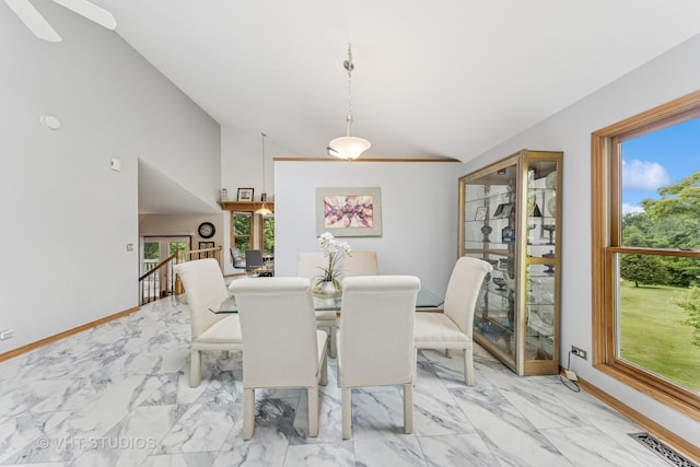 841 Bonnie Brae Ln, Bolingbrook, IL 60440 - dining area with vaulted ceiling, light marble finish floors, and baseboards