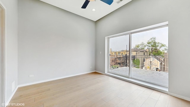 2712 N Artesian Ave Unit 3, Chicago, IL 60647 - empty room with light wood-style floors, ceiling fan, baseboards, and a high ceiling