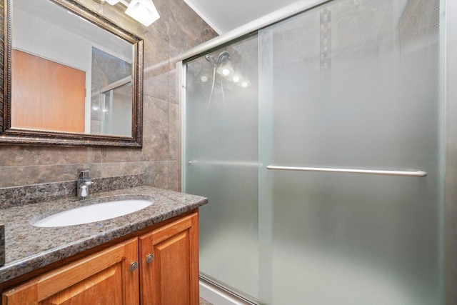 975 Patriot Ln, Hoffman Estates, IL 60192 - bathroom featuring vanity, a shower with shower door, and tile walls