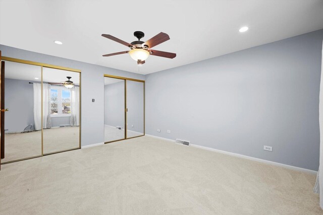 975 Patriot Ln, Hoffman Estates, IL 60192 - unfurnished bedroom with multiple closets, carpet flooring, recessed lighting, and baseboards