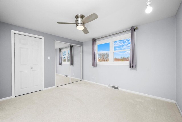975 Patriot Ln, Hoffman Estates, IL 60192 - unfurnished bedroom with multiple closets, carpet, and baseboards
