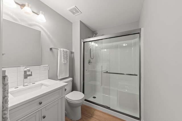 1802 77th St, Naperville, IL 60565 - bathroom featuring toilet, a stall shower, vanity, backsplash, and wood finished floors
