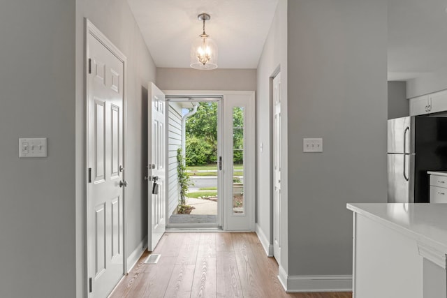 1802 77th St, Naperville, IL 60565 - entrance foyer featuring a chandelier, light wood finished floors, and baseboards