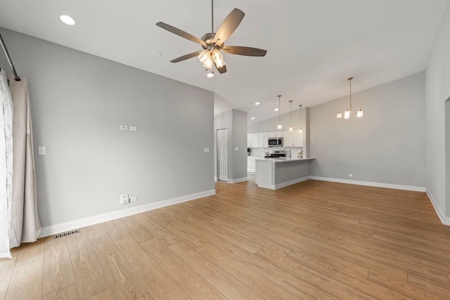 1802 77th St, Naperville, IL 60565 - unfurnished living room with lofted ceiling, a ceiling fan, a chandelier, baseboards, and light wood-style floors
