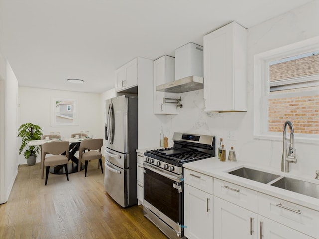 3455 W 115th St, Chicago, IL 60655 - kitchen featuring stainless steel appliances, wall chimney exhaust hood, white cabinets, light countertops, and wood finished floors
