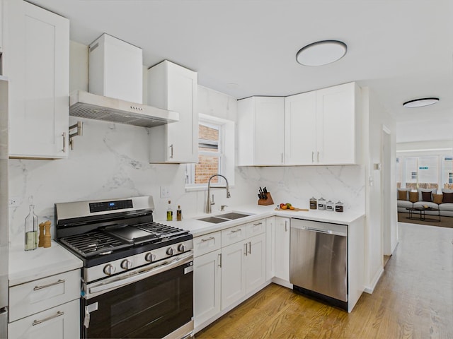 3455 W 115th St, Chicago, IL 60655 - kitchen featuring stainless steel appliances, wall chimney range hood, light countertops, light wood-style floors, and decorative backsplash