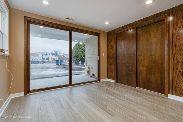 2413 20th St, North Chicago, IL 60064 - unfurnished bedroom with access to exterior, light wood-style flooring, baseboards, recessed lighting, and a closet