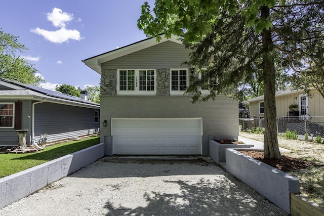 1525 Grove Dr, Round Lake Beach, IL 60073 - view of front of home featuring driveway, a garage, and brick siding