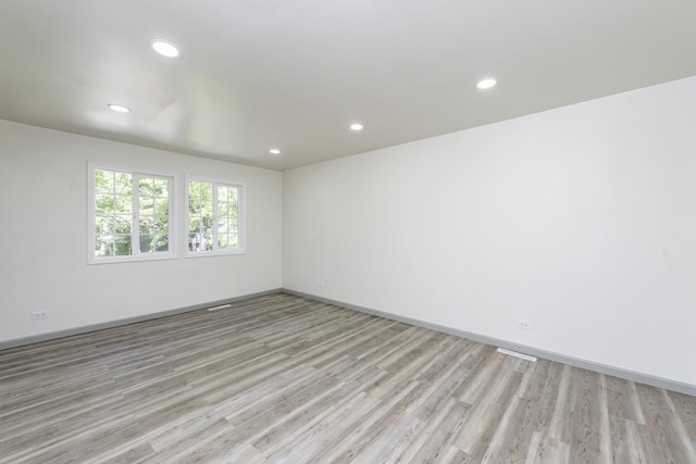 1525 Grove Dr, Round Lake Beach, IL 60073 - unfurnished room with light wood-type flooring, recessed lighting, and baseboards