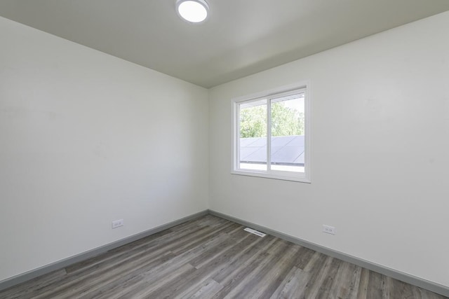 1525 Grove Dr, Round Lake Beach, IL 60073 - unfurnished room with wood finished floors and baseboards