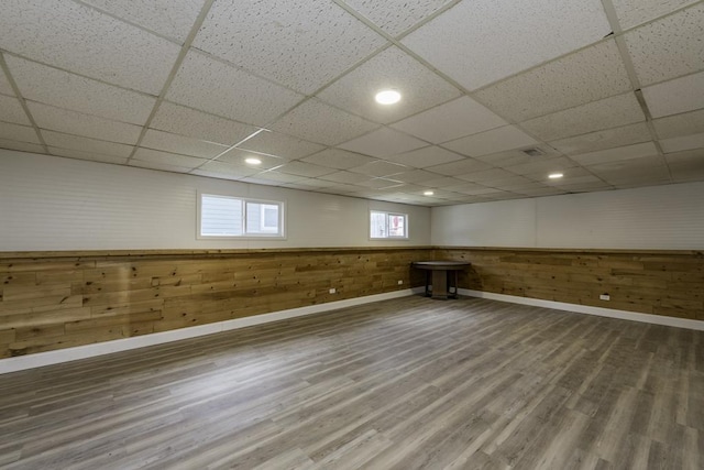 1525 Grove Dr, Round Lake Beach, IL 60073 - below grade area featuring baseboards, wood finished floors, a paneled ceiling, and wooden walls