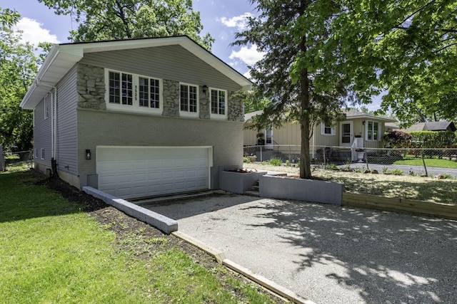 1525 Grove Dr, Round Lake Beach, IL 60073 - view of front facade featuring driveway, an attached garage, brick siding, and stone siding