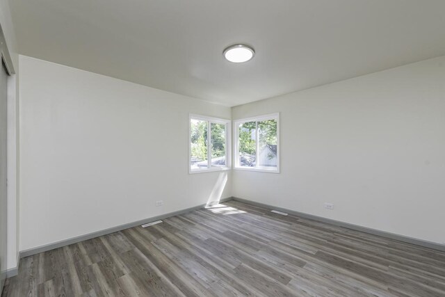 1525 Grove Dr, Round Lake Beach, IL 60073 - unfurnished room featuring wood finished floors and baseboards