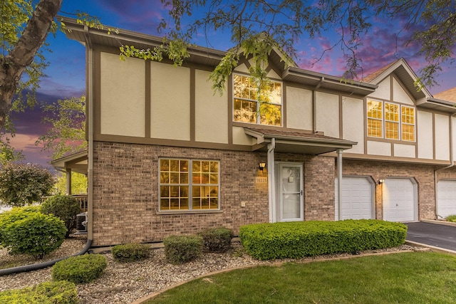 18225 Eagle Dr, Tinley Park, IL 60477 - view of front facade featuring stucco siding, driveway, an attached garage, and brick siding