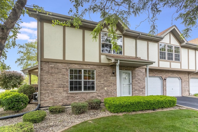 18225 Eagle Dr, Tinley Park, IL 60477 - view of front of house with stucco siding, a garage, driveway, and brick siding