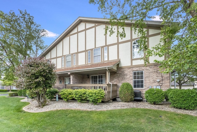 18225 Eagle Dr, Tinley Park, IL 60477 - back of property featuring stucco siding, a lawn, brick siding, and central AC
