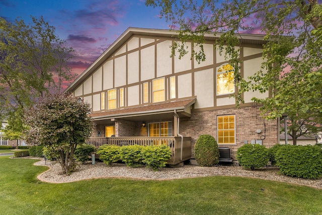18225 Eagle Dr, Tinley Park, IL 60477 - view of front of home with stucco siding, a front yard, brick siding, and central air condition unit