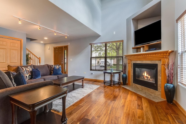18225 Eagle Dr, Tinley Park, IL 60477 - living room with stairs, track lighting, wood finished floors, baseboards, and a fireplace
